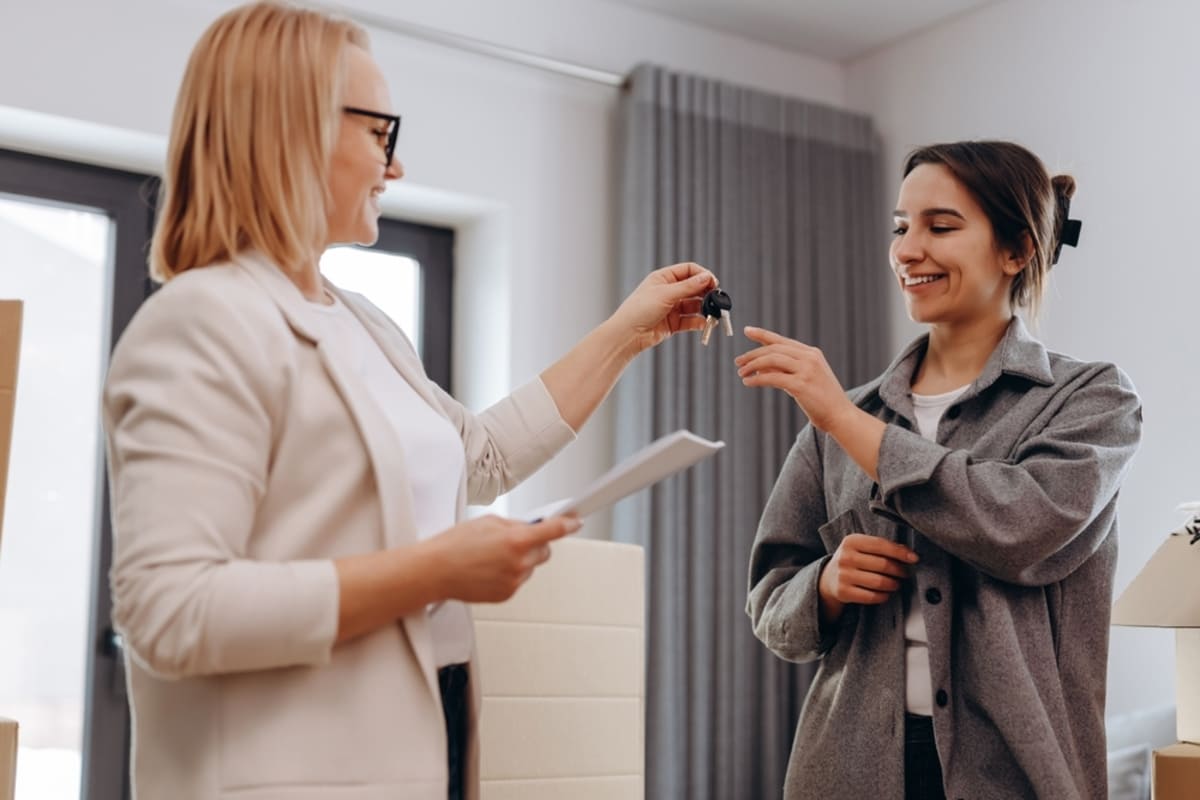 A woman handing a tenant keys