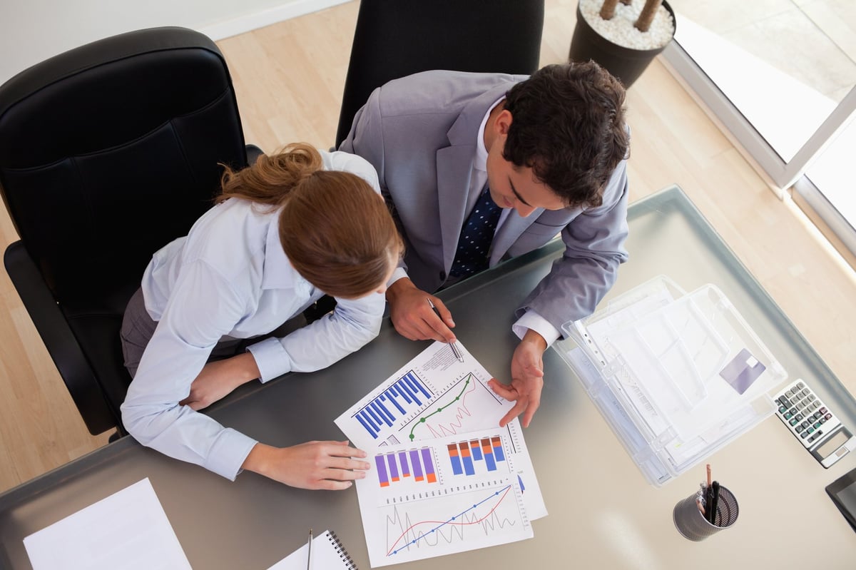 Above view of consultant analyzing data with her client