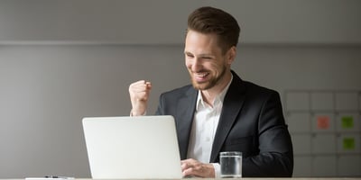 A man working on a laptop in an office