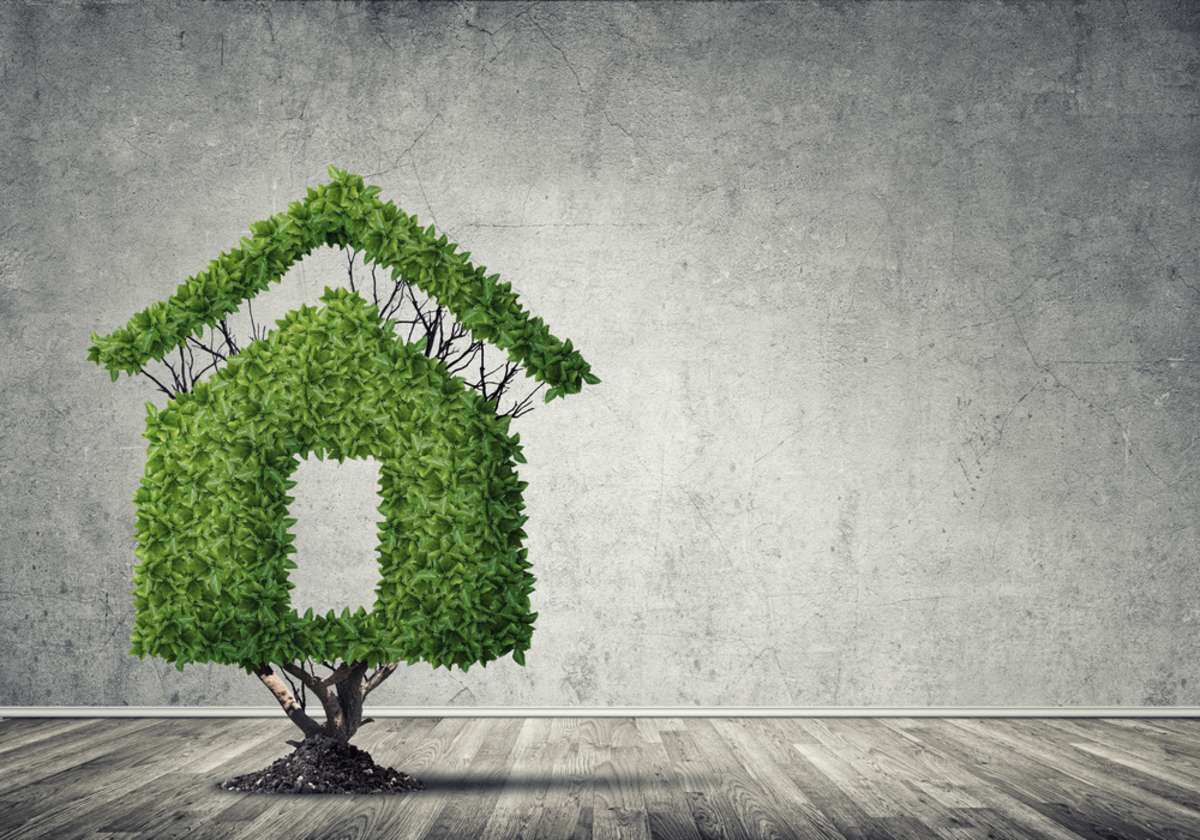 A house made of green leaves, investing in real estate concept