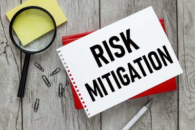 A notebook that says risk mitigation