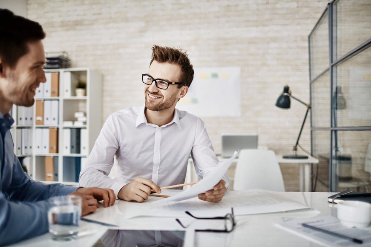 Businessmen meeting and reviewing documents, property management consultant concept
