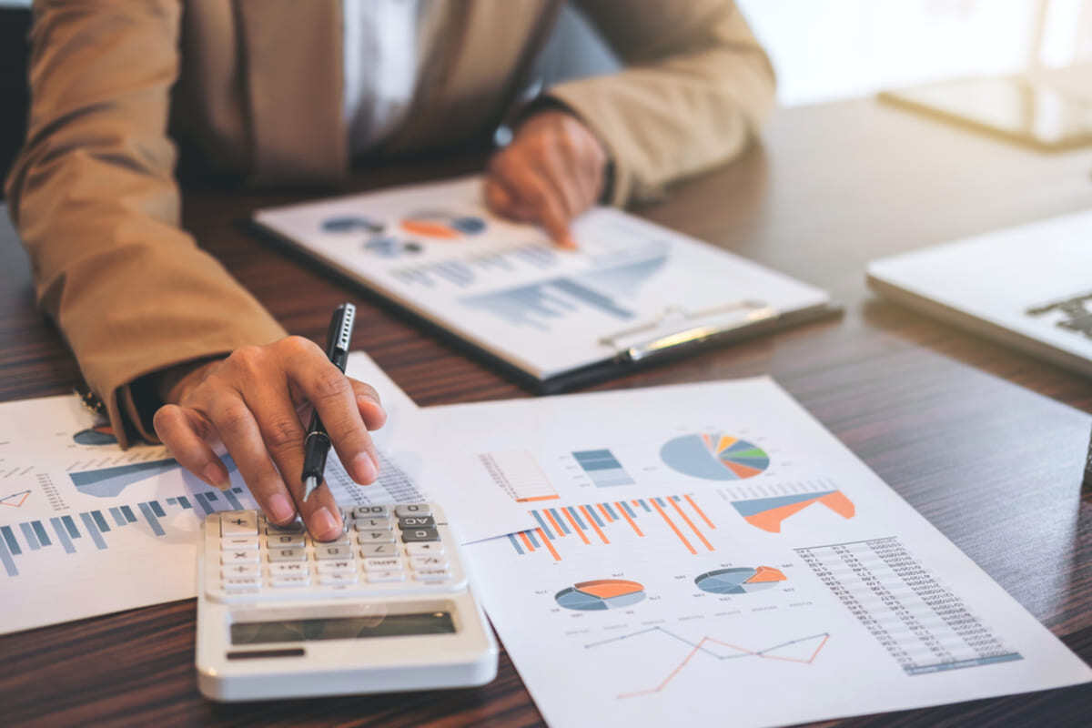 Close-up of a person working on a budget, rental property maintenance budget