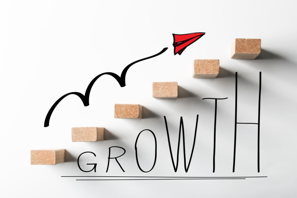 Growth with blocks moving upward, property management solutions deliver growth concept