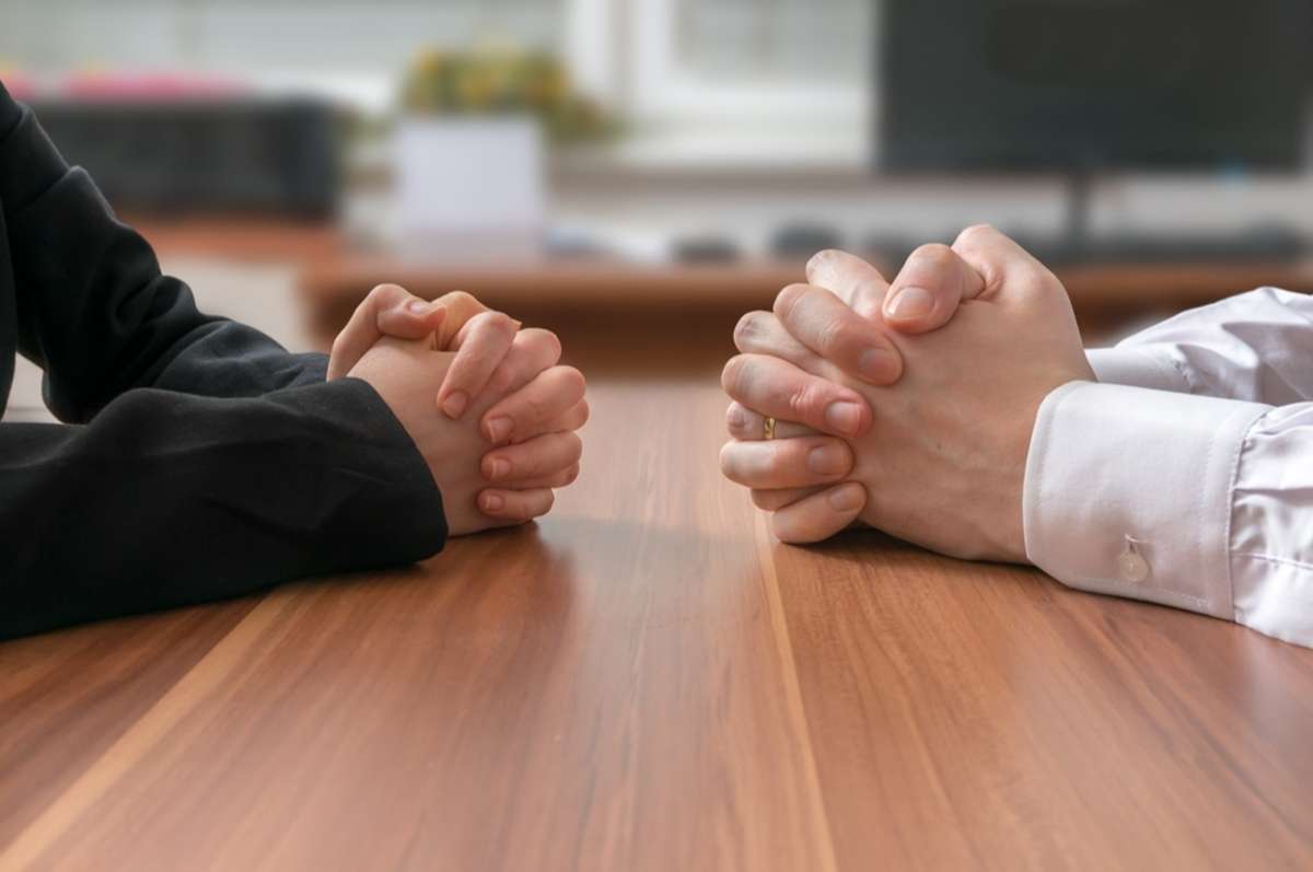 Negotiation of two statesman with clasped hands in office