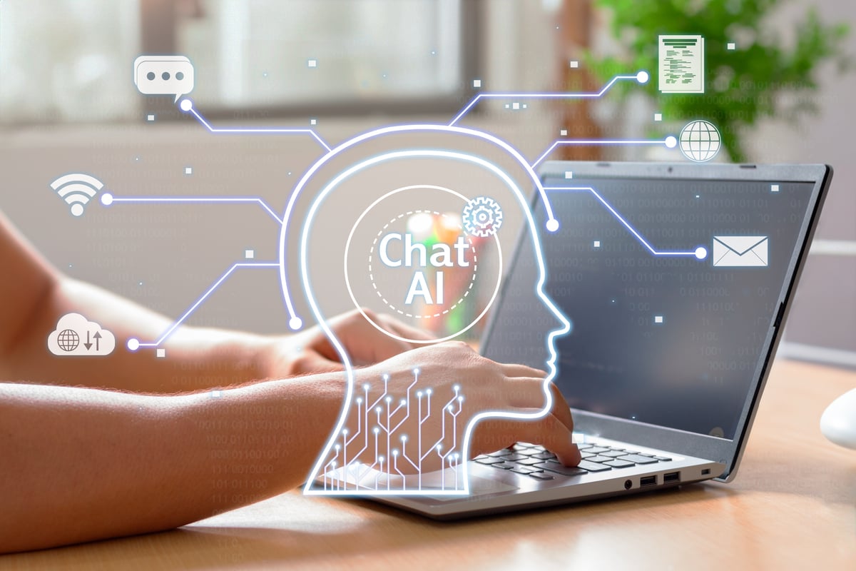 Someone typing on a laptop with a graphic overlay that says chat AI