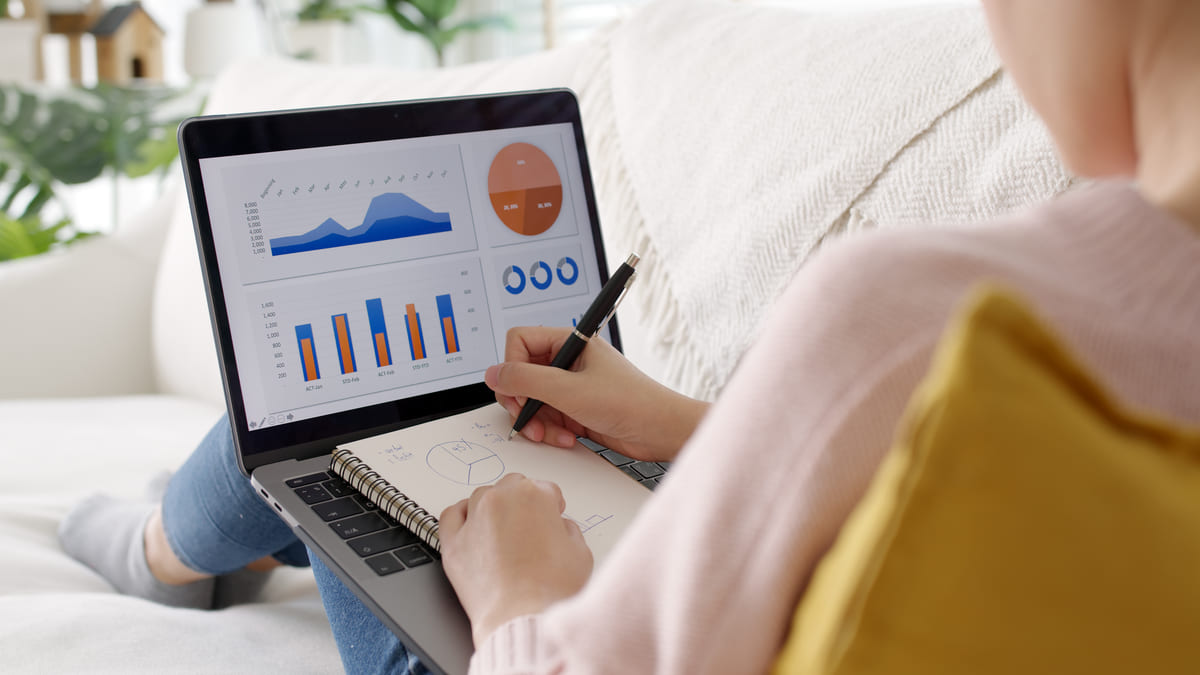 Woman on laptop researching real estate