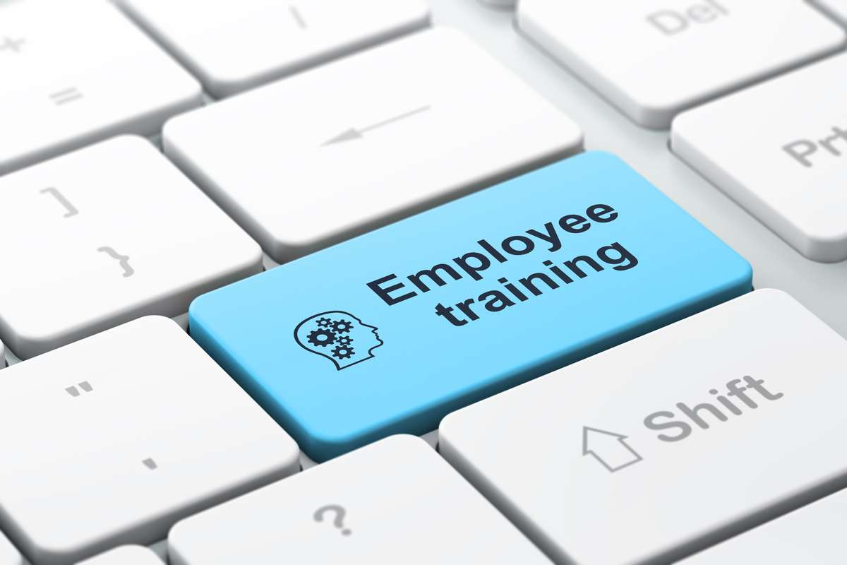 Education concept Head With Gears and Employee Training on comp (R) (S)