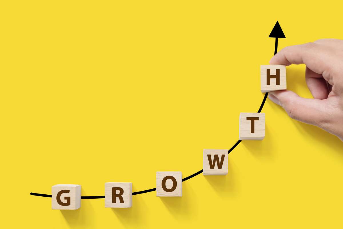 Arrows showing growth on a yellow background, property management success concept