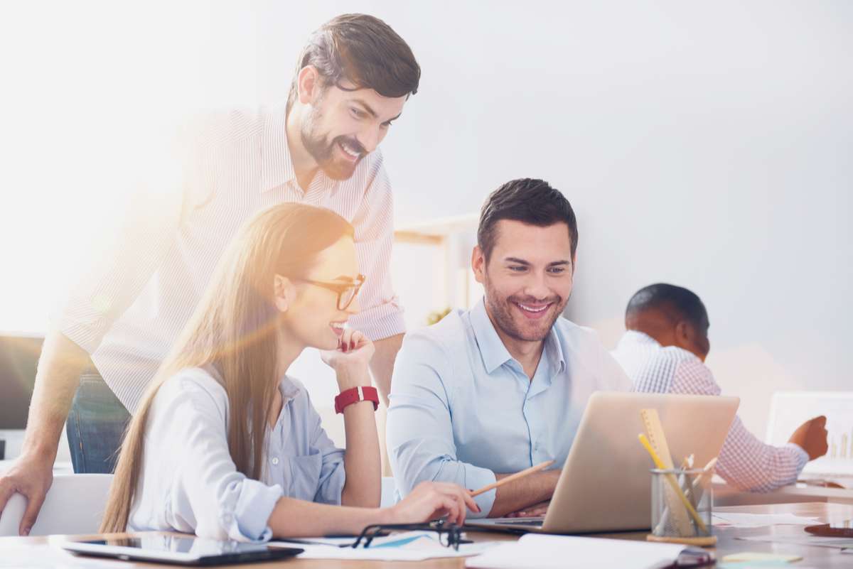 Bearded man checking results of workers