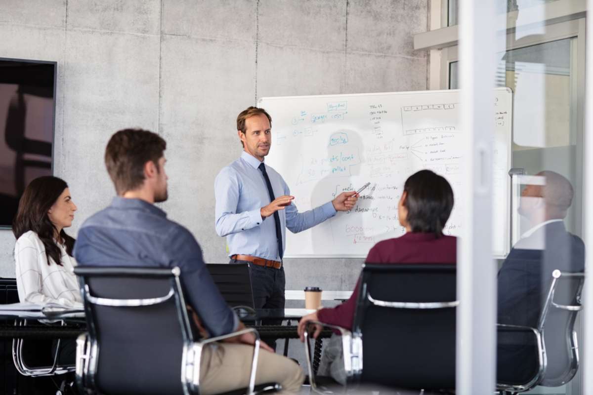 Businessman giving a presentation with colleagues, property management success concept. 