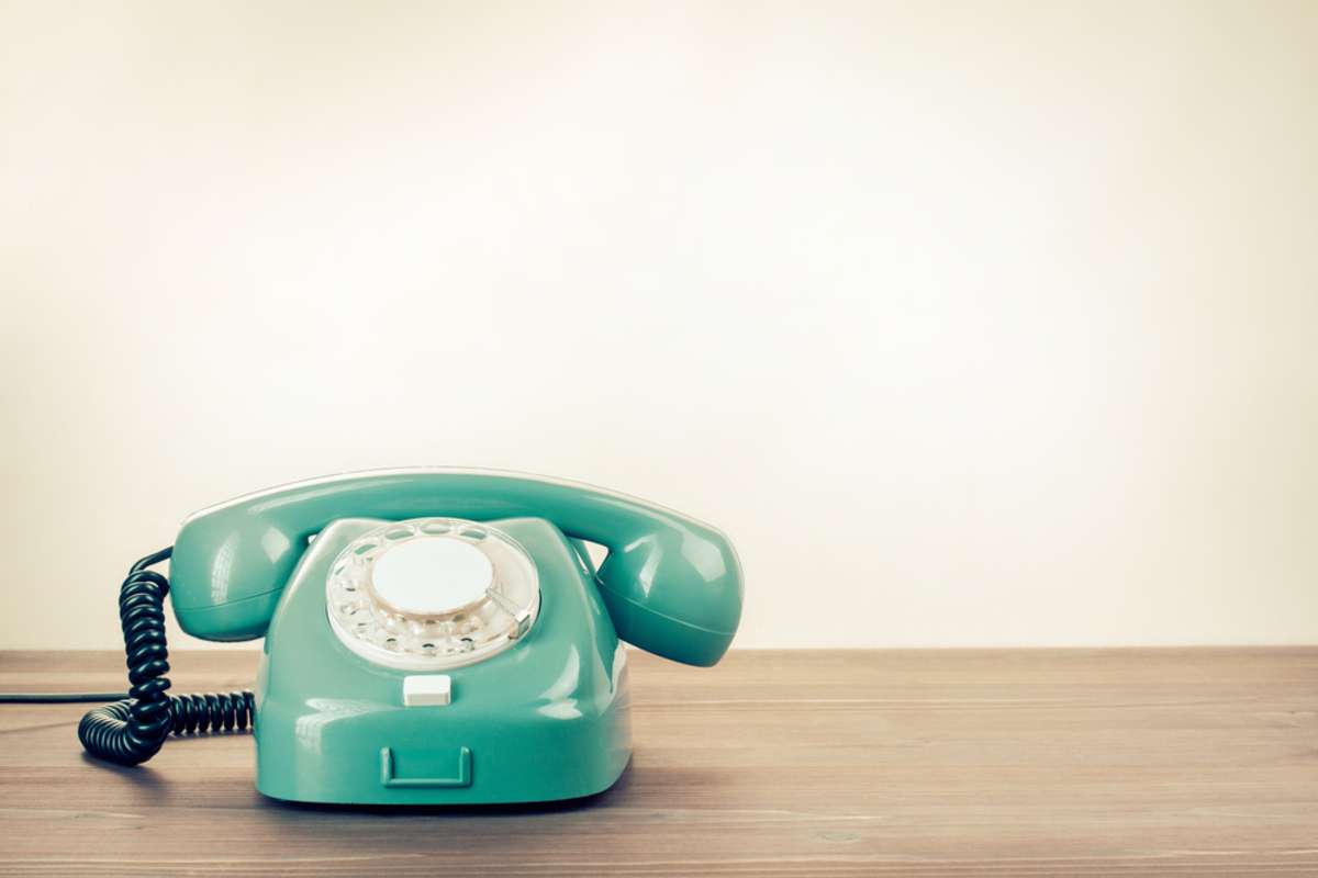 Retro rotary telephone on wood table