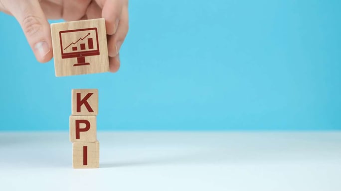 Wooden blocks with the word KPI - measuring property management success concept