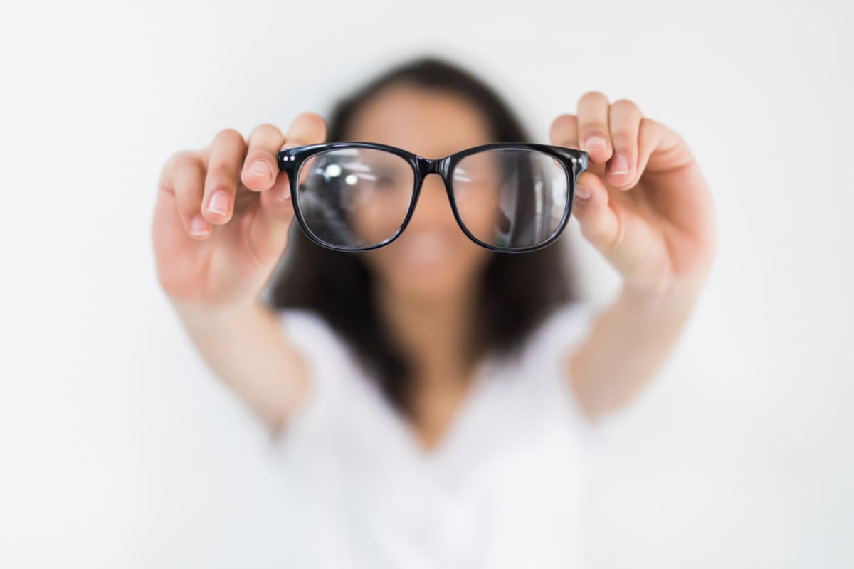 A woman blurred with a pair of glasses in focused, fresh eyes of property management consulting services concept