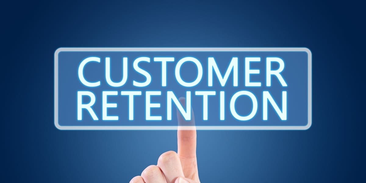 The words customer retention being pointed at by a hand