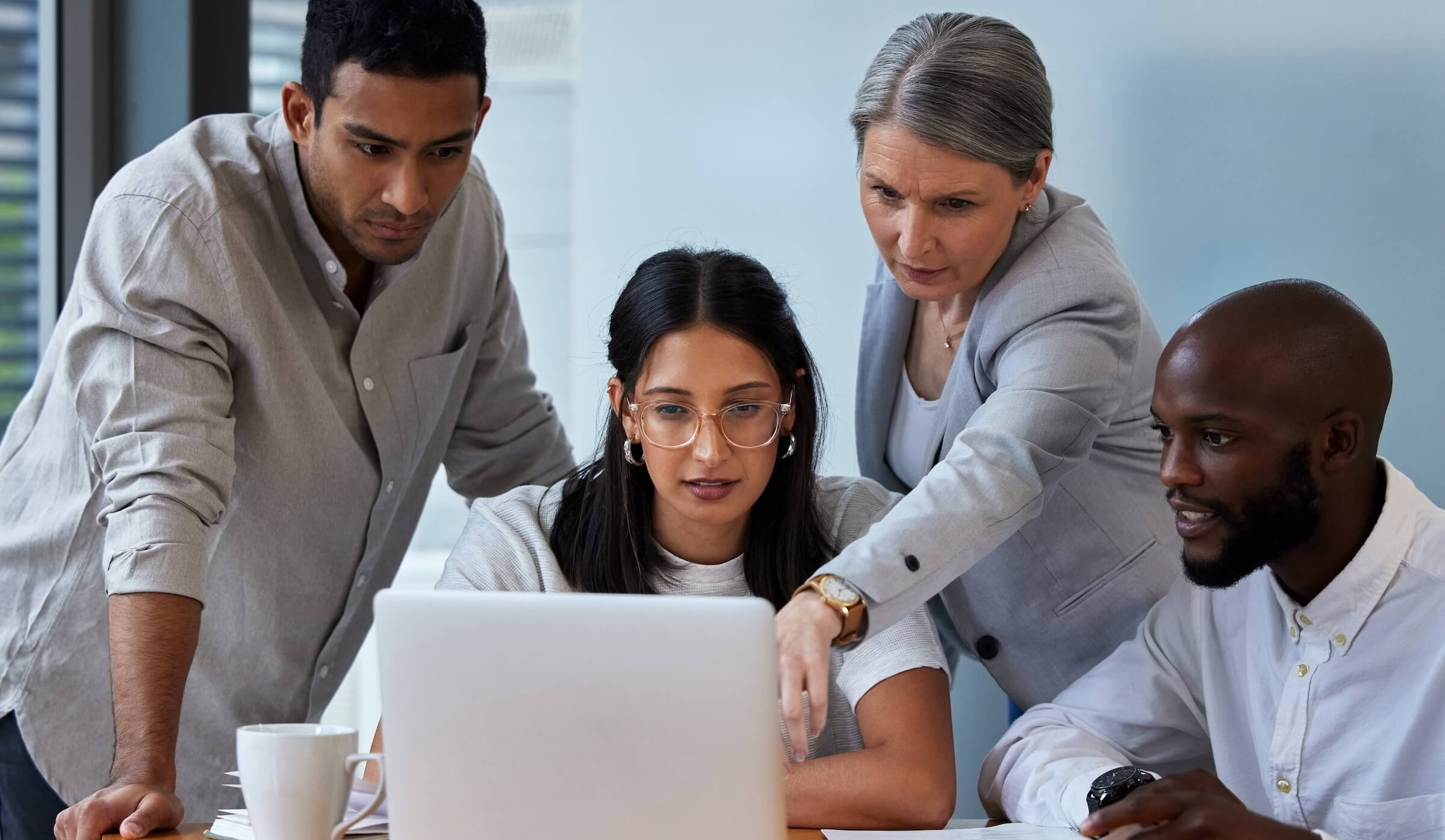 Property management team reviewing monthly reports on computer