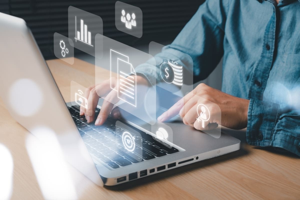 Male typing on a laptop doing research on real estate
