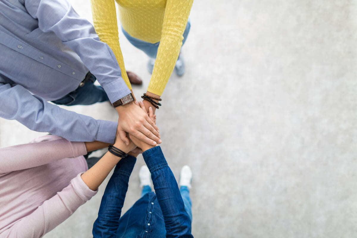 People with their hands in a huddle