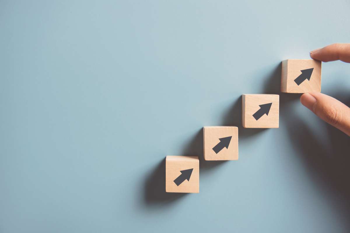 Photo of arrows in wooden blocks lined up pointing at an upward direction