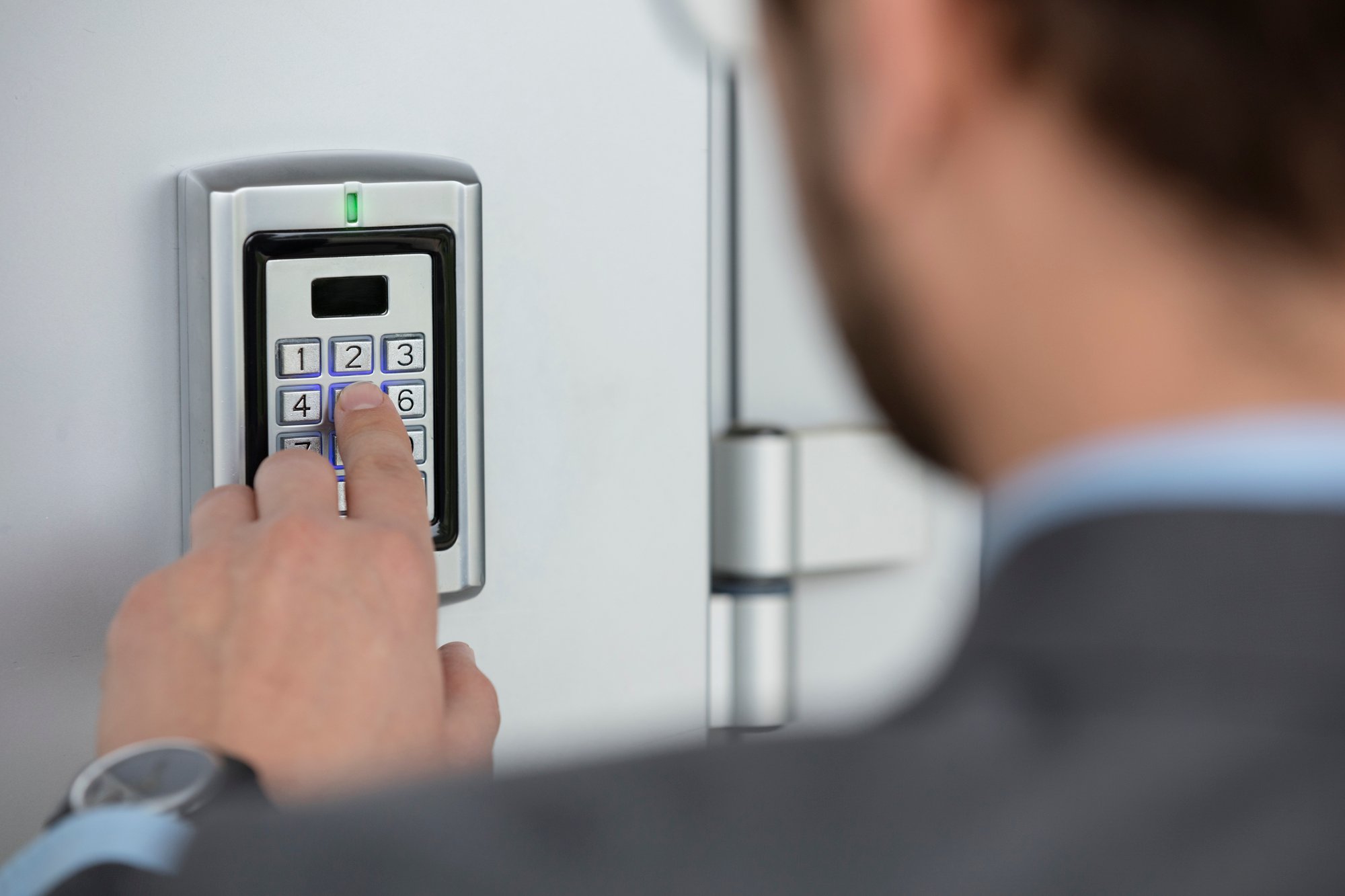 A man setting up lock code on an electronic lock