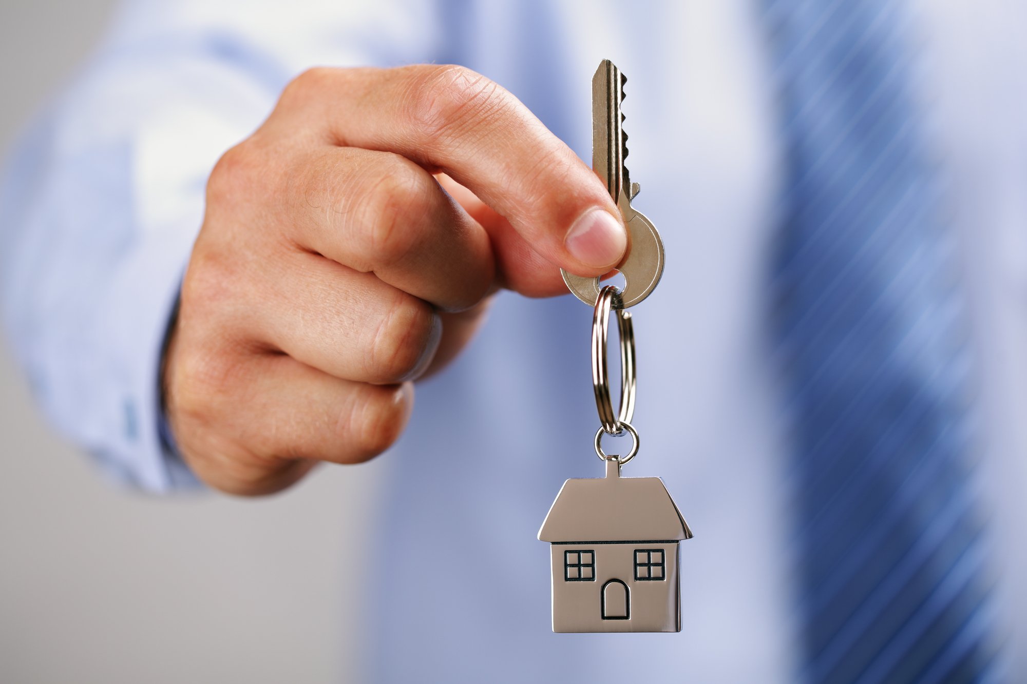 Real estate agent holding house keys