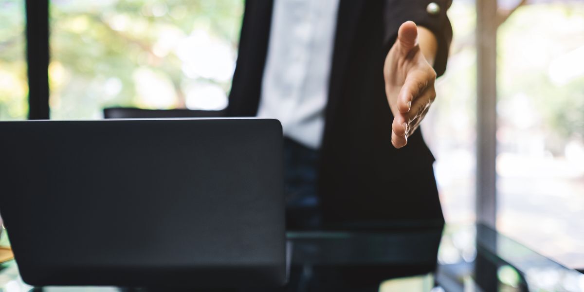 Businesspeople open hand to shaking hands in office