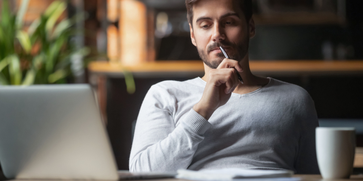 4 Pensive bearded man sitting at table