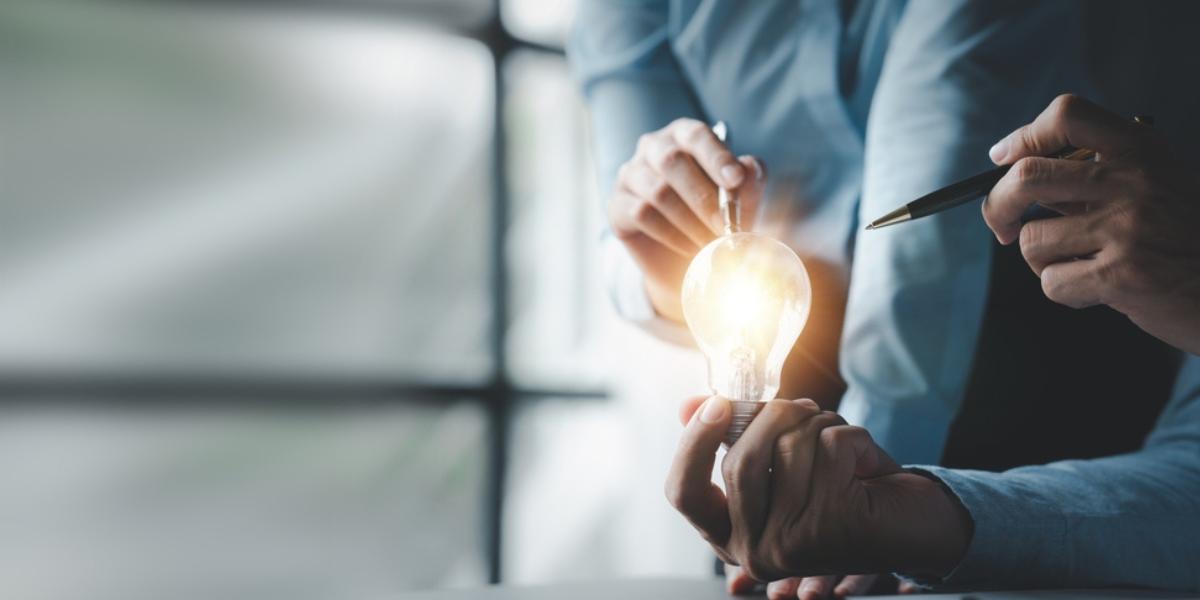 Businessman holds a glowing lamp, Creative new idea