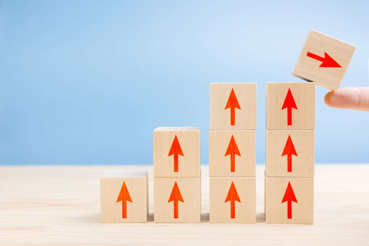 Blocks and arrows showing growth, growing property management company concept