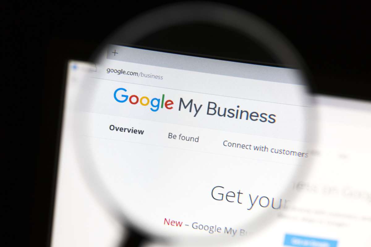 Magnifying glass used on a laptop screen to magnify words Google My Business