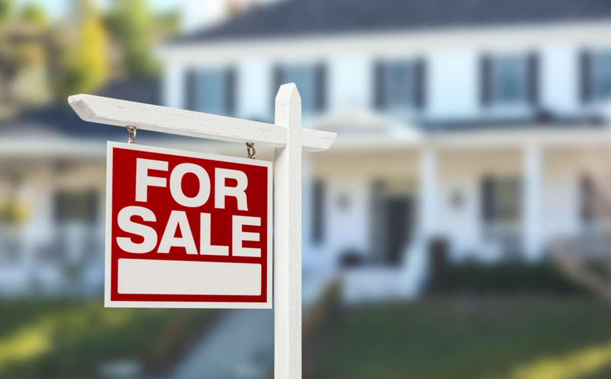 For sale sign in front of a house