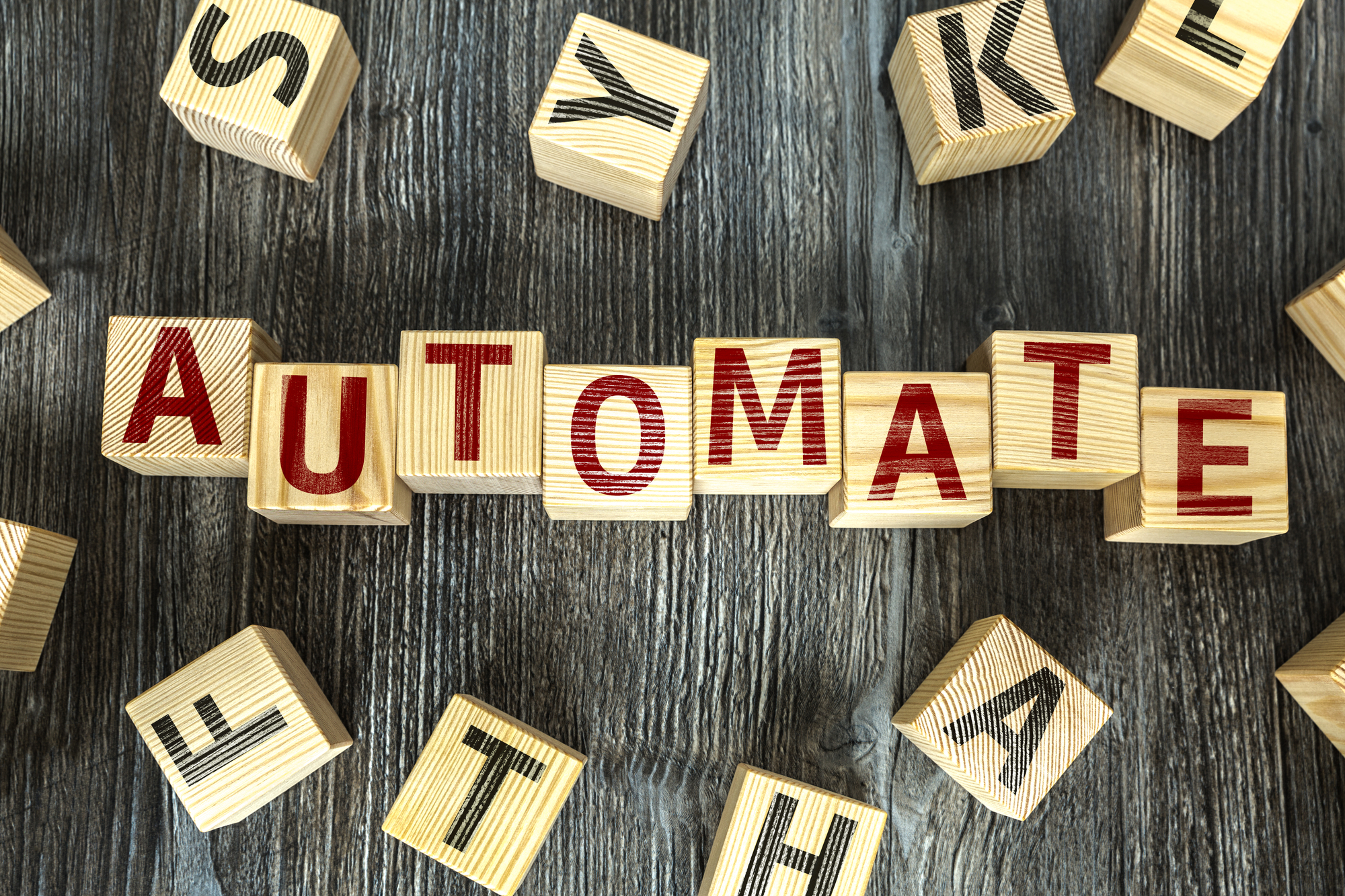 The word automate spelled with wooden alphabet blocks