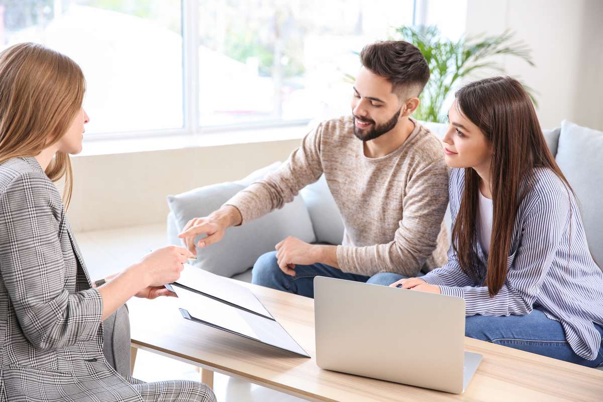 A couple making a deal with a businessman